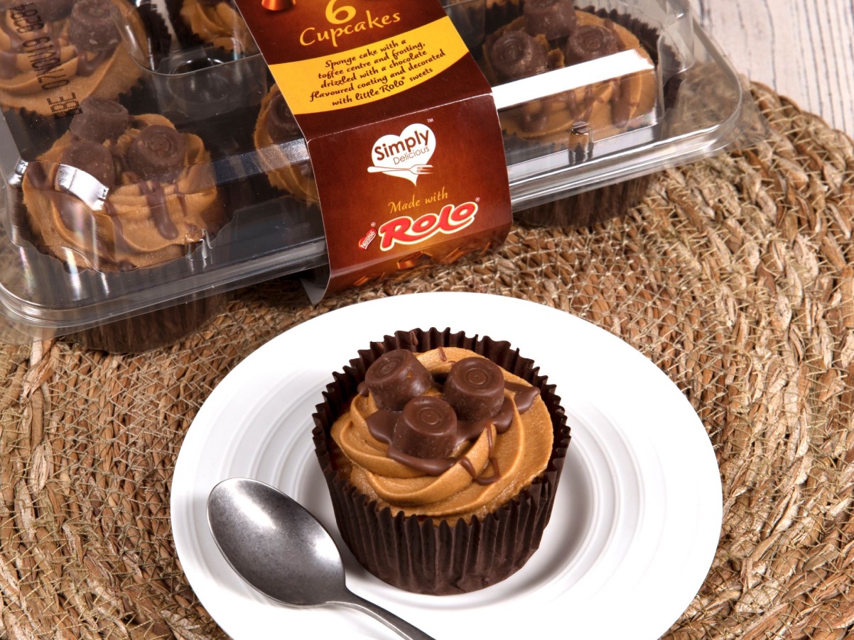 Chocolate cupcakes on a plate with a spoon, presented beautifully by a PR agency.