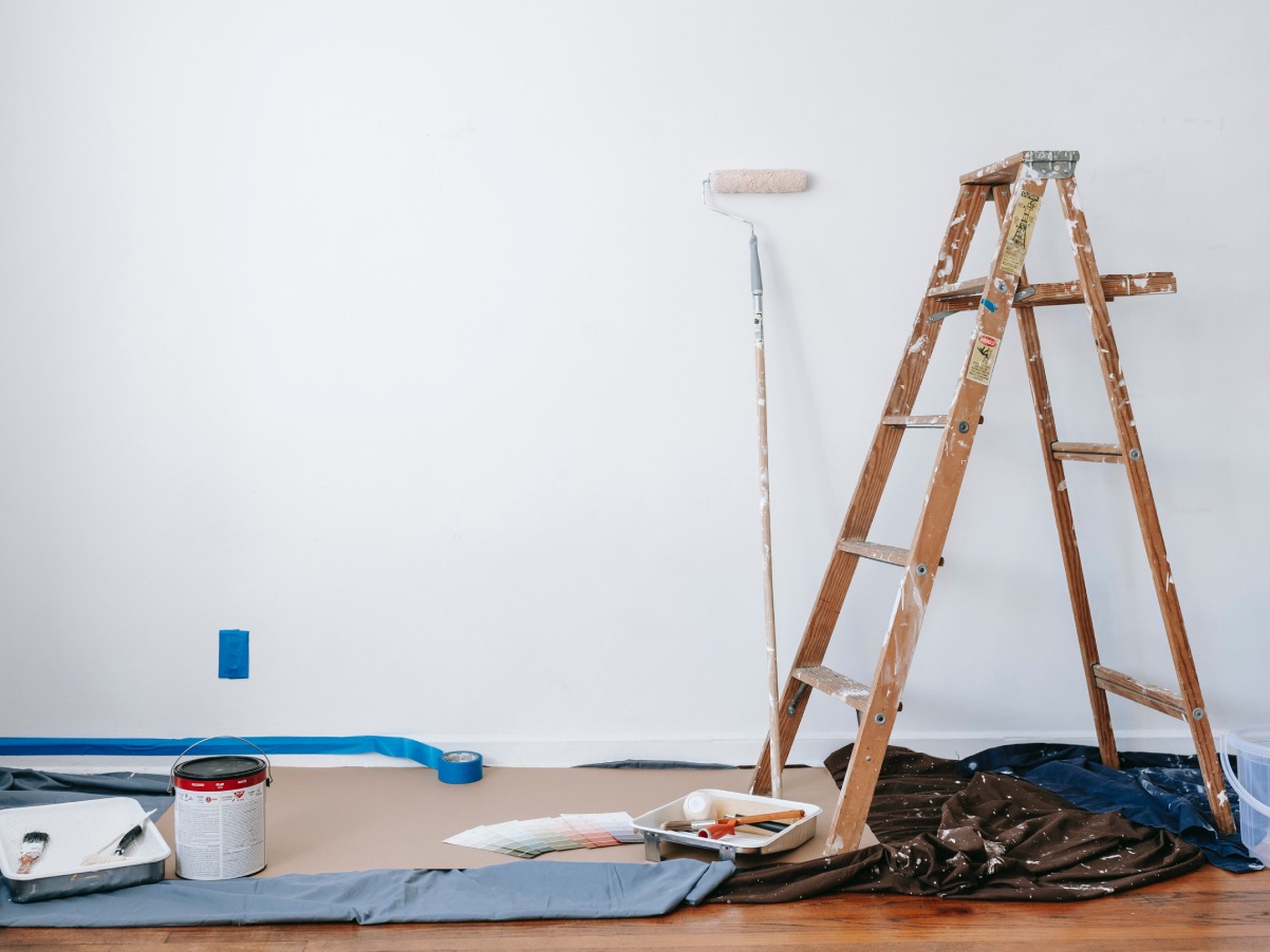 Modify the description: Utilizing a ladder and paint, a PR agency provides top-notch PR services to transform and revitalize a room through painting.